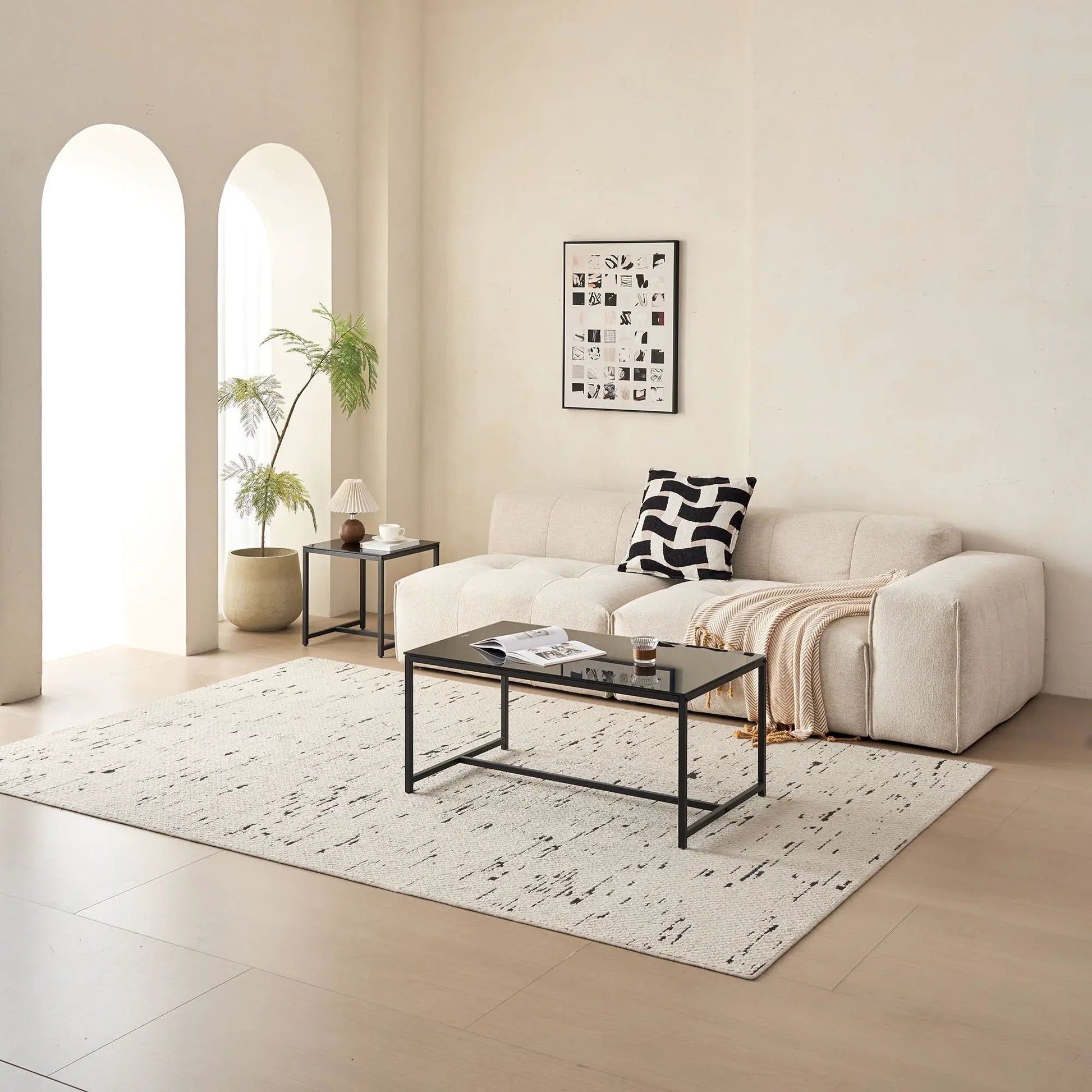 Living room coffee tables (2) with black metal frames and glass tops beside a beige sofa on Tampa Home & Garden Store