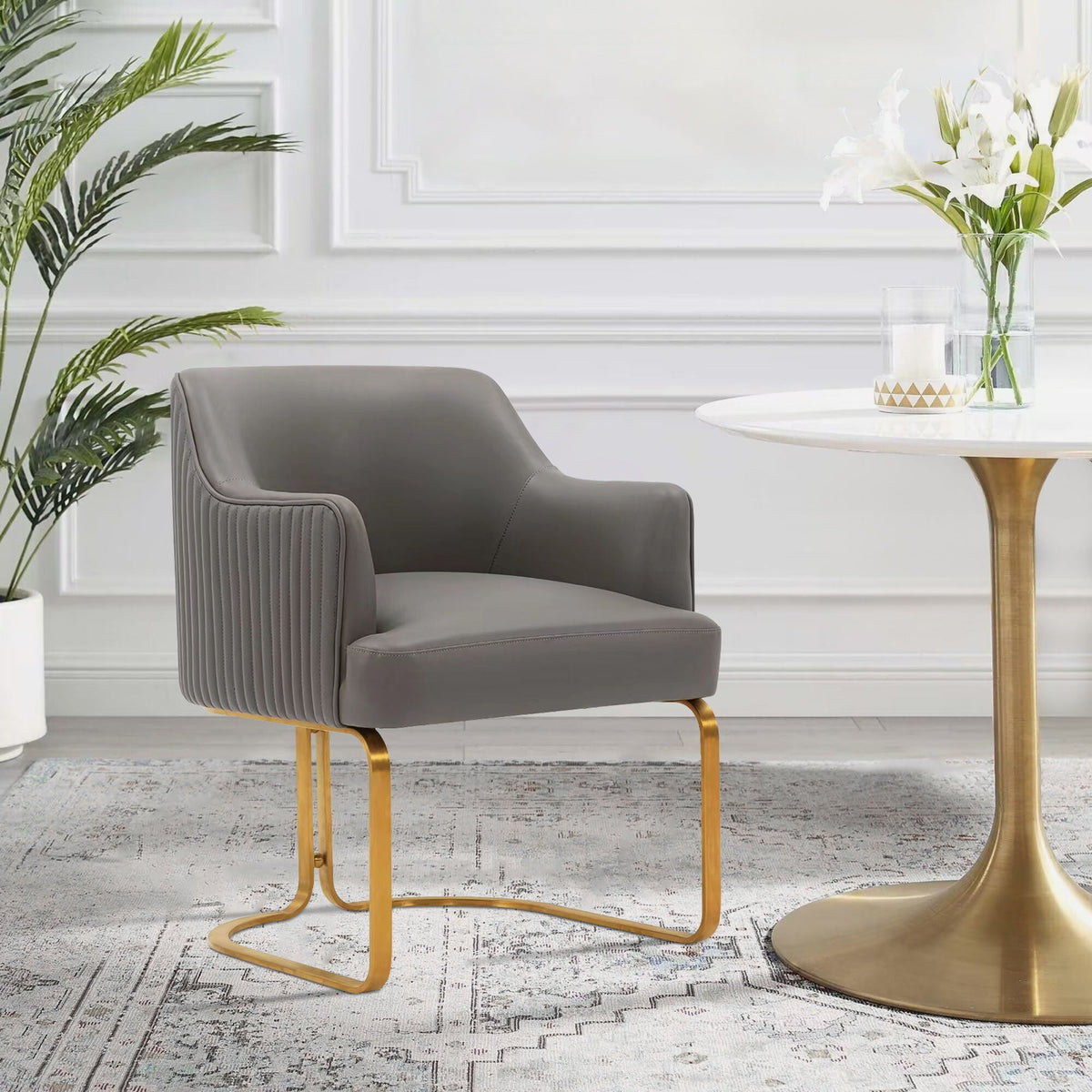 Modern arm chair dark gray upholstery with gold cantilever legs on Tampa Home & Garden Store