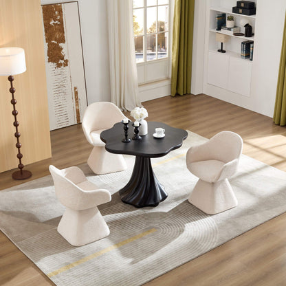 Sculptural round dining table black with petal-shaped top and root-textured pedestal on Tampa Home & Garden Store