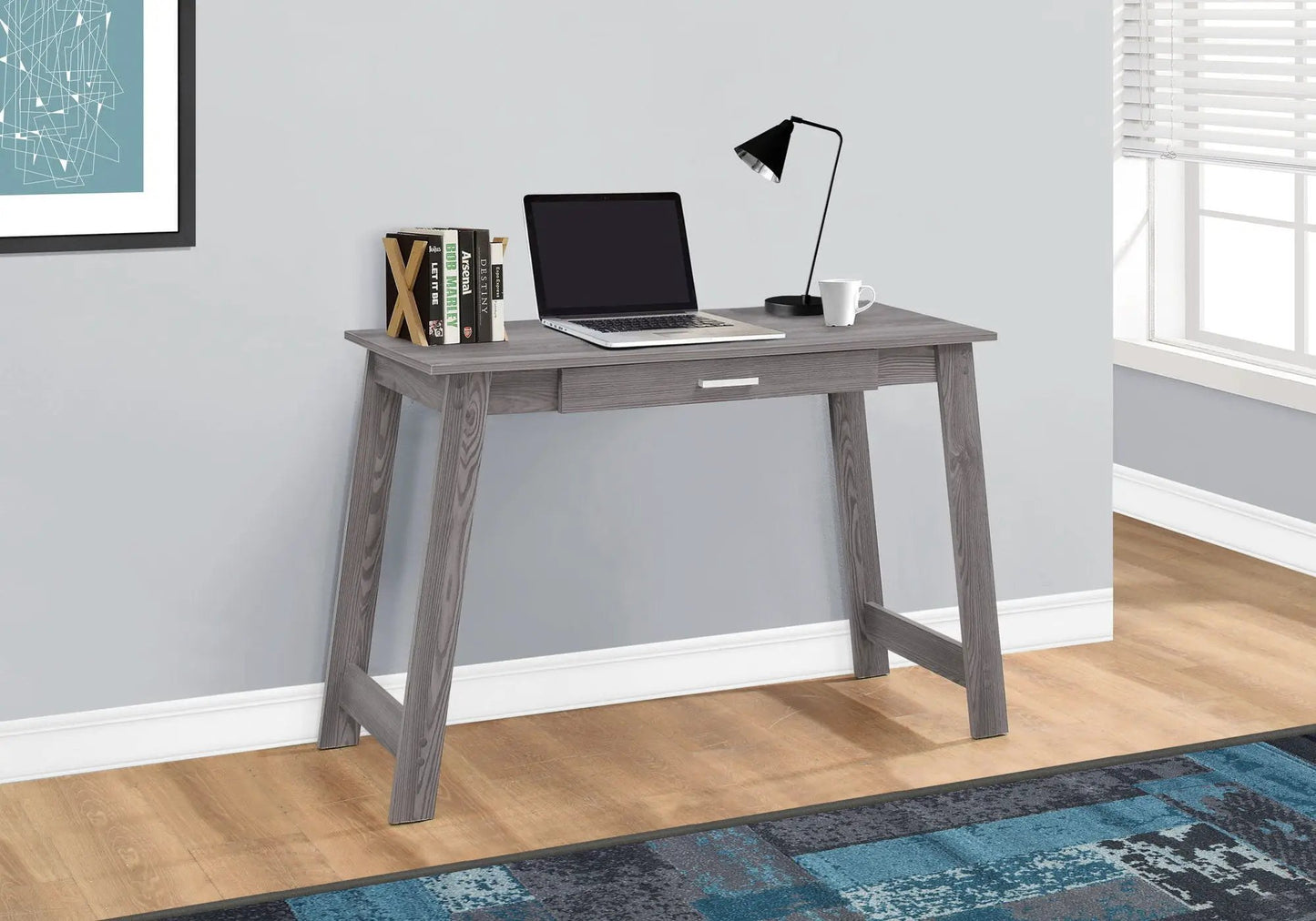 Stylish design computer desk in gray wood finish with laptop, lamp and books on Tampa Home & Garden Store