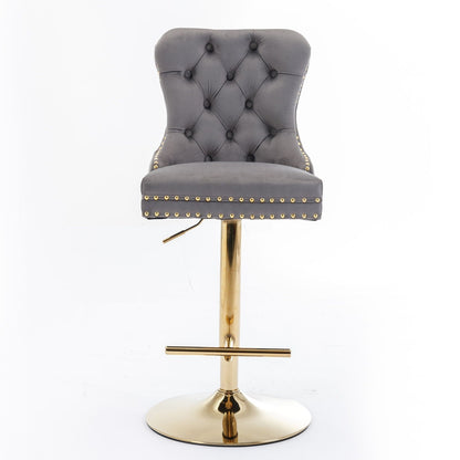 Grey tufted swivel bar stool with gold nailhead trim and brass pedestal base on Tampa Home & Garden Store