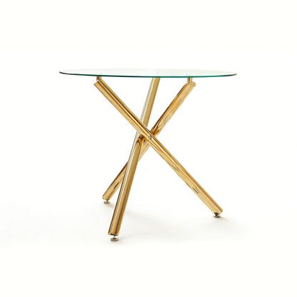 Dining table by HouseOfZazla with round glass top and gold crisscross legs on Tampa Home & Garden Store