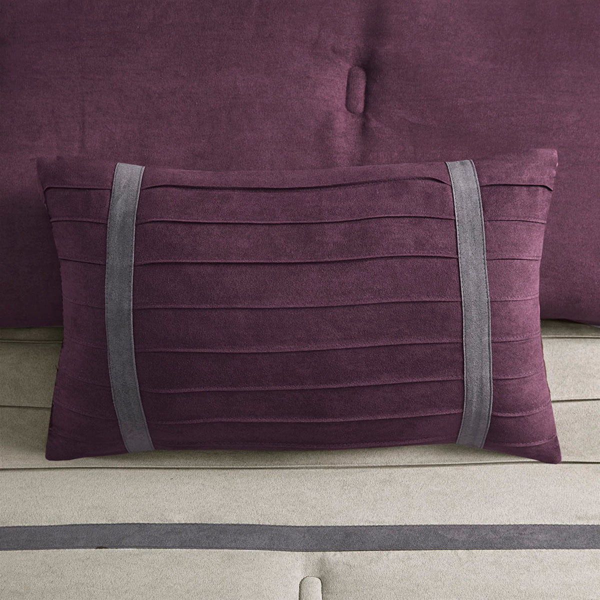 Decorative purple faux suede pillow with horizontal pleats and gray strap accents on Tampa Home & Garden Store