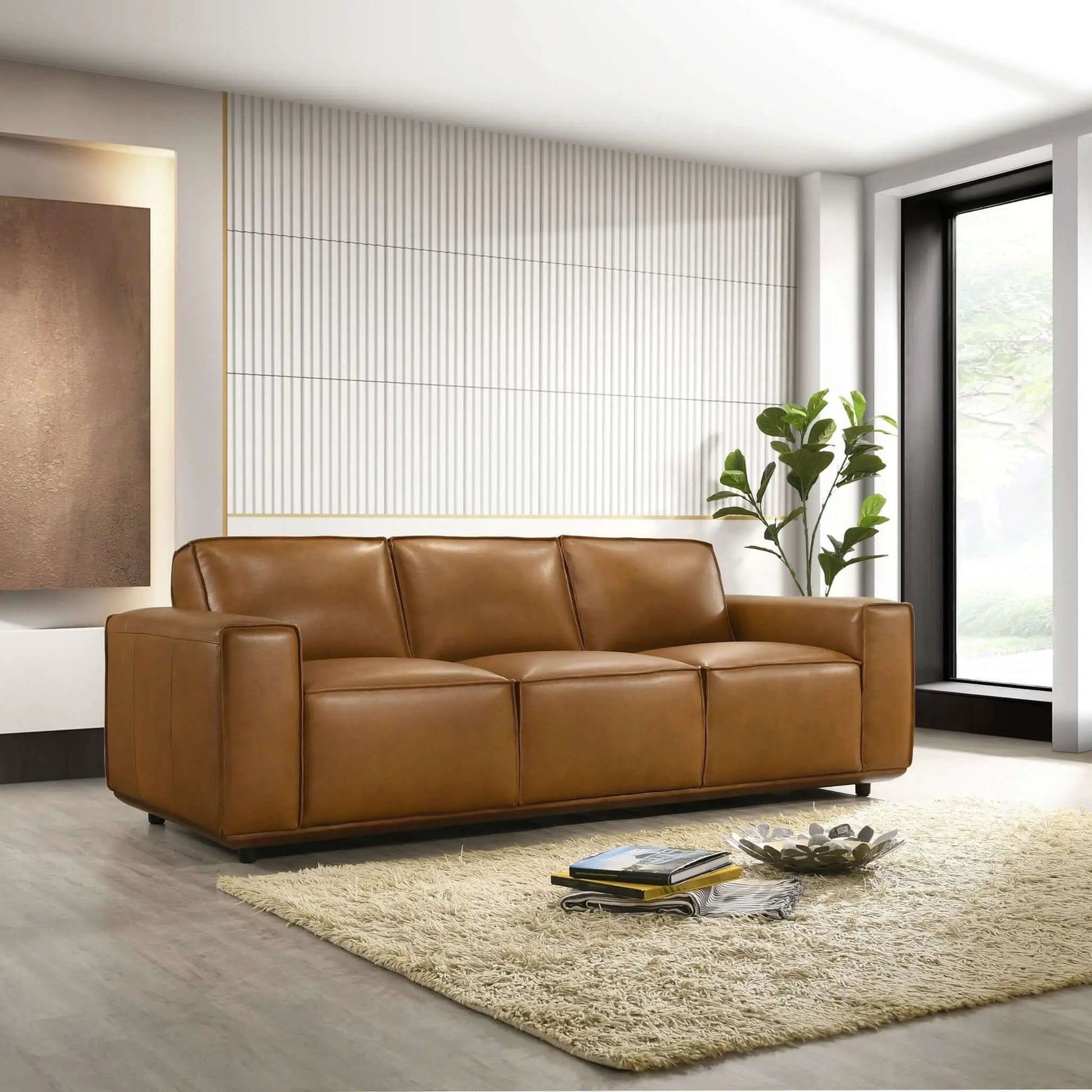 Hanky sofa brown tan leather couch in a modern living room with beige rug and green plants on Tampa Home & Garden Store
