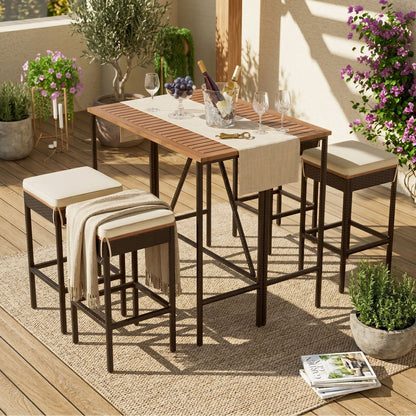 Outdoor acacia wood bar-height dining table with eight beige-c Cushioned stools and slatted top on Tampa Home & Garden Store