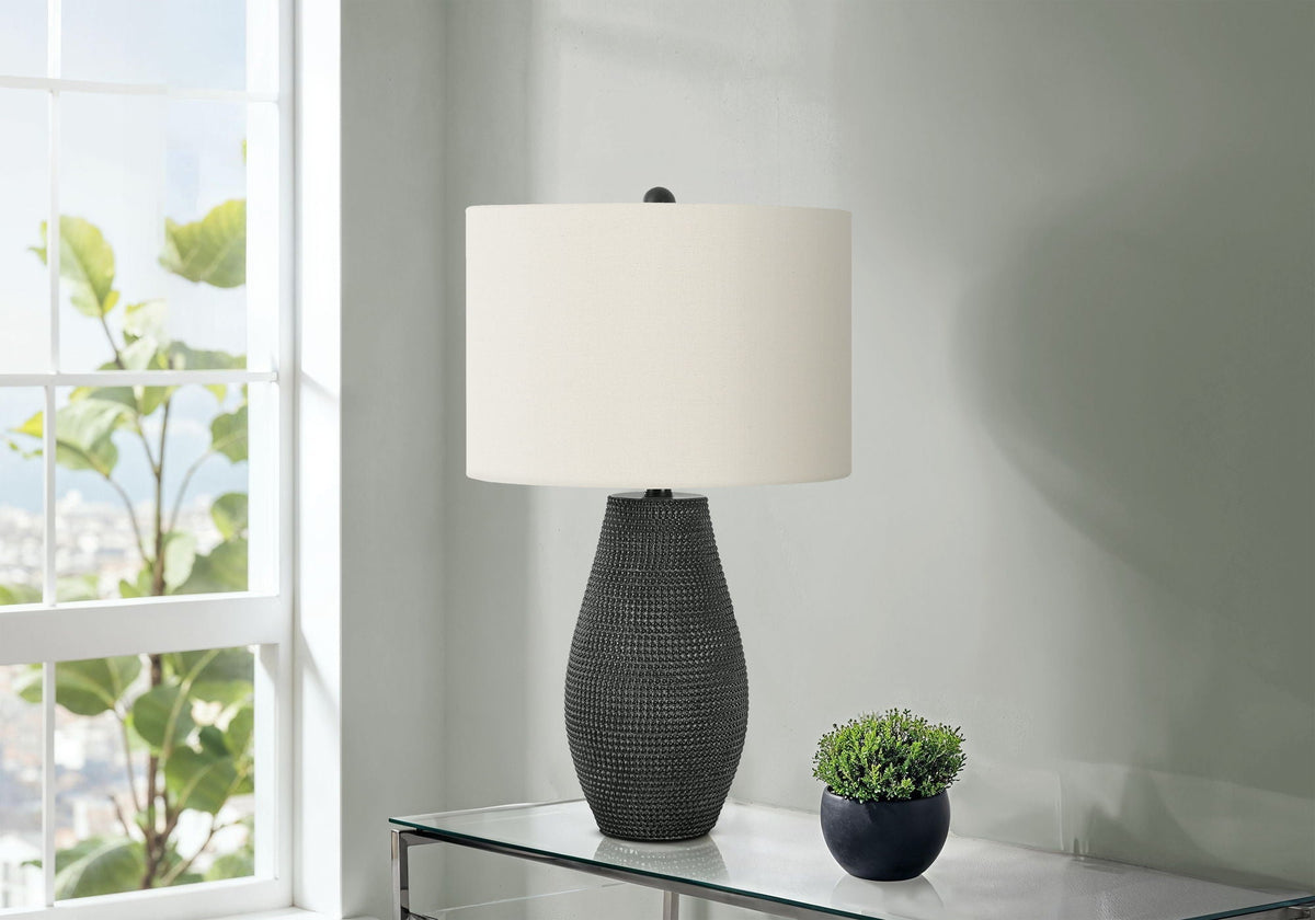 Table lamp black resin base with cream shade; include 2 small potted shrubs on glass table on Tampa Home & Garden Store