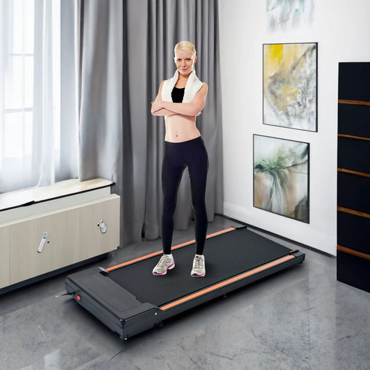 Desk treadmill 300 lb capacity with black deck and orange trim, user standing on it on Tampa Home & Garden Store