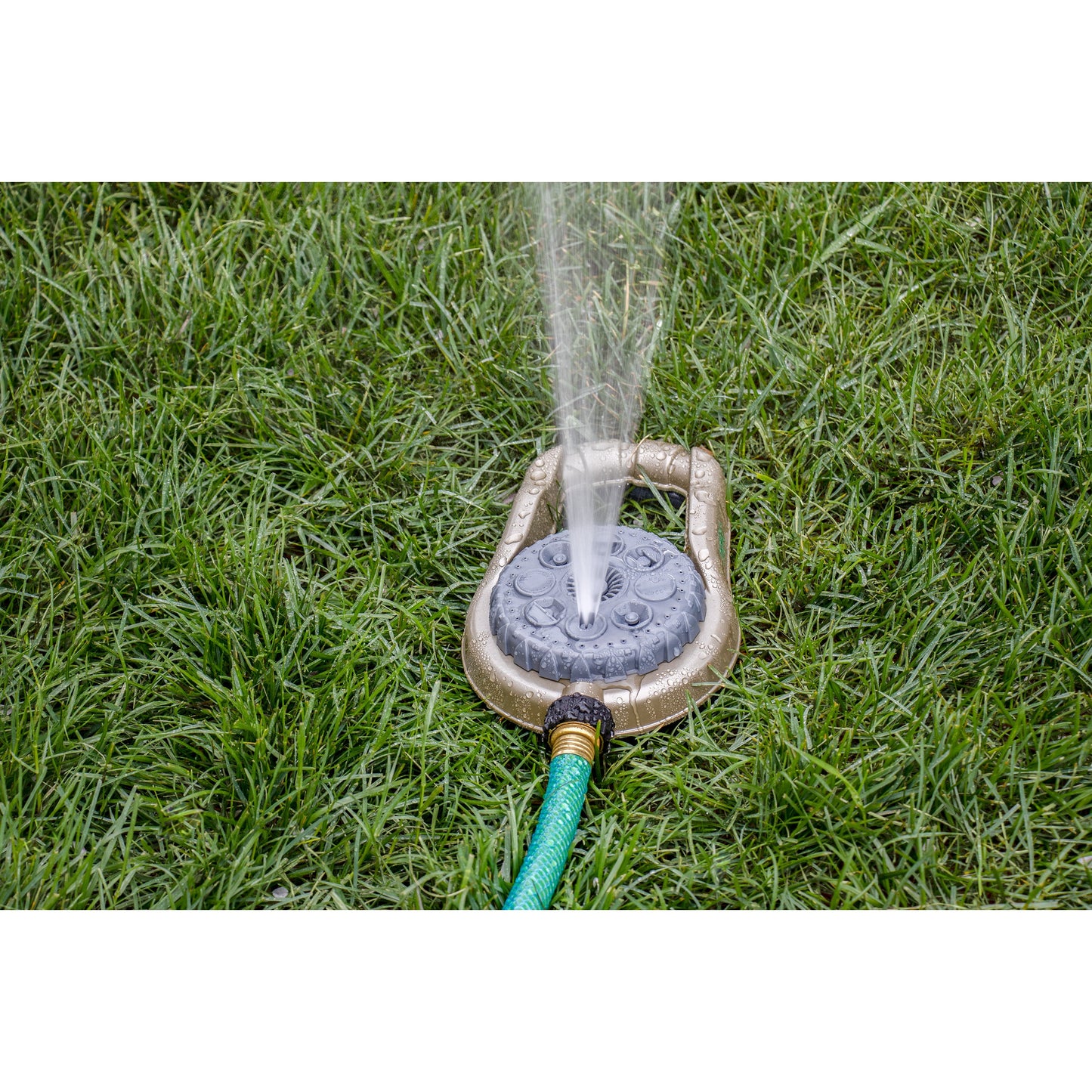 Orbit Irrigation metal 8-pattern lawn sprinkler on weighted base spraying water on lawn on Tampa Home & Garden Store