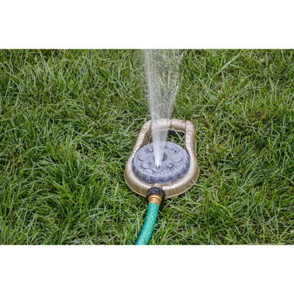 Orbit Irrigation metal 8-pattern lawn sprinkler on weighted base spraying water on lawn on Tampa Home & Garden Store
