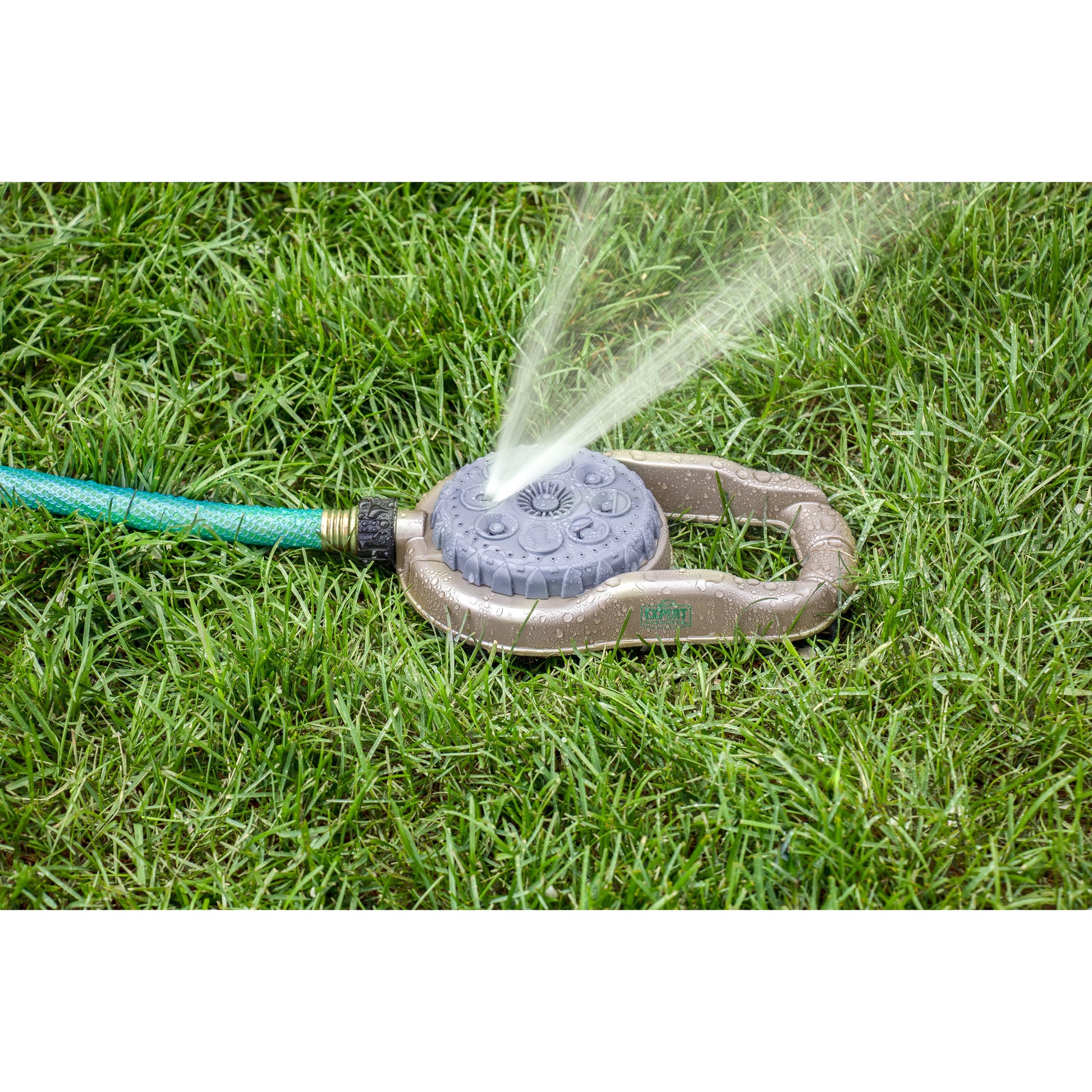 Orbit Irrigation metal 8-pattern lawn sprinkler on weighted base spraying lawn on Tampa Home & Garden Store