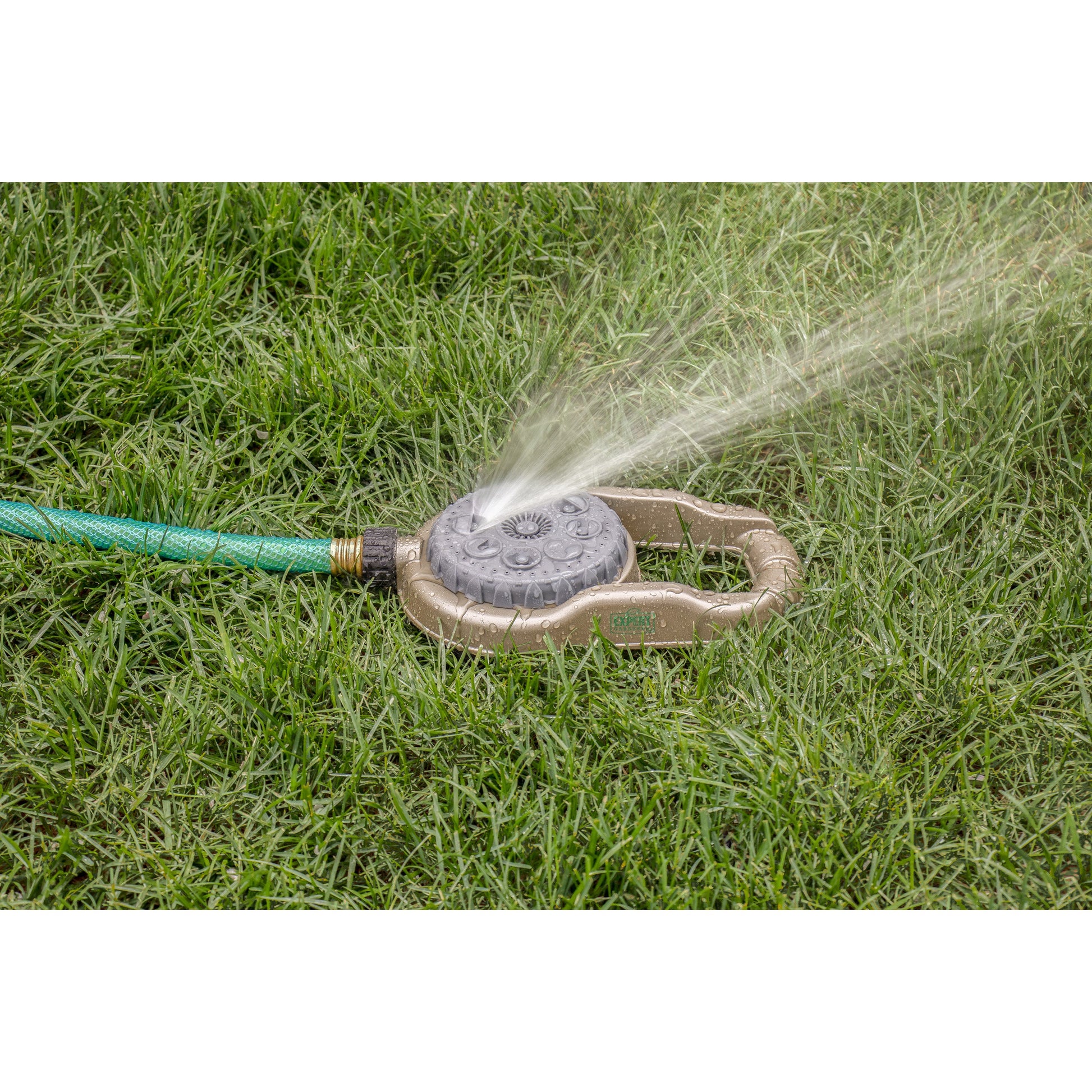 Metal lawn sprinkler Orbit Irrigation 8-pattern hose end on weighted base spraying grass on Tampa Home & Garden Store