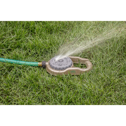 Metal lawn sprinkler Orbit Irrigation 8-pattern hose end on weighted base spraying grass on Tampa Home & Garden Store