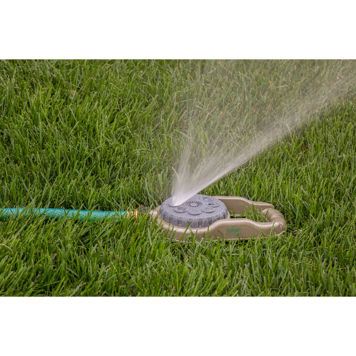 Metal 8-Pattern Sprinkler on Weighted Base by Orbit Irrigation spraying grass on Tampa Home & Garden Store