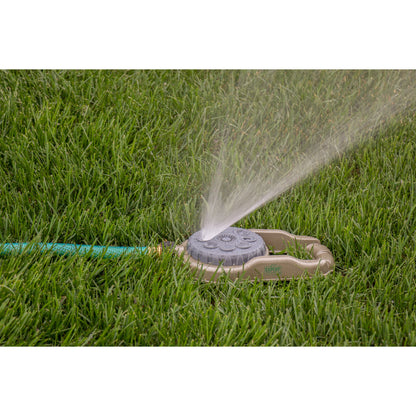 Metal 8-Pattern Sprinkler on Weighted Base by Orbit Irrigation spraying grass on Tampa Home & Garden Store