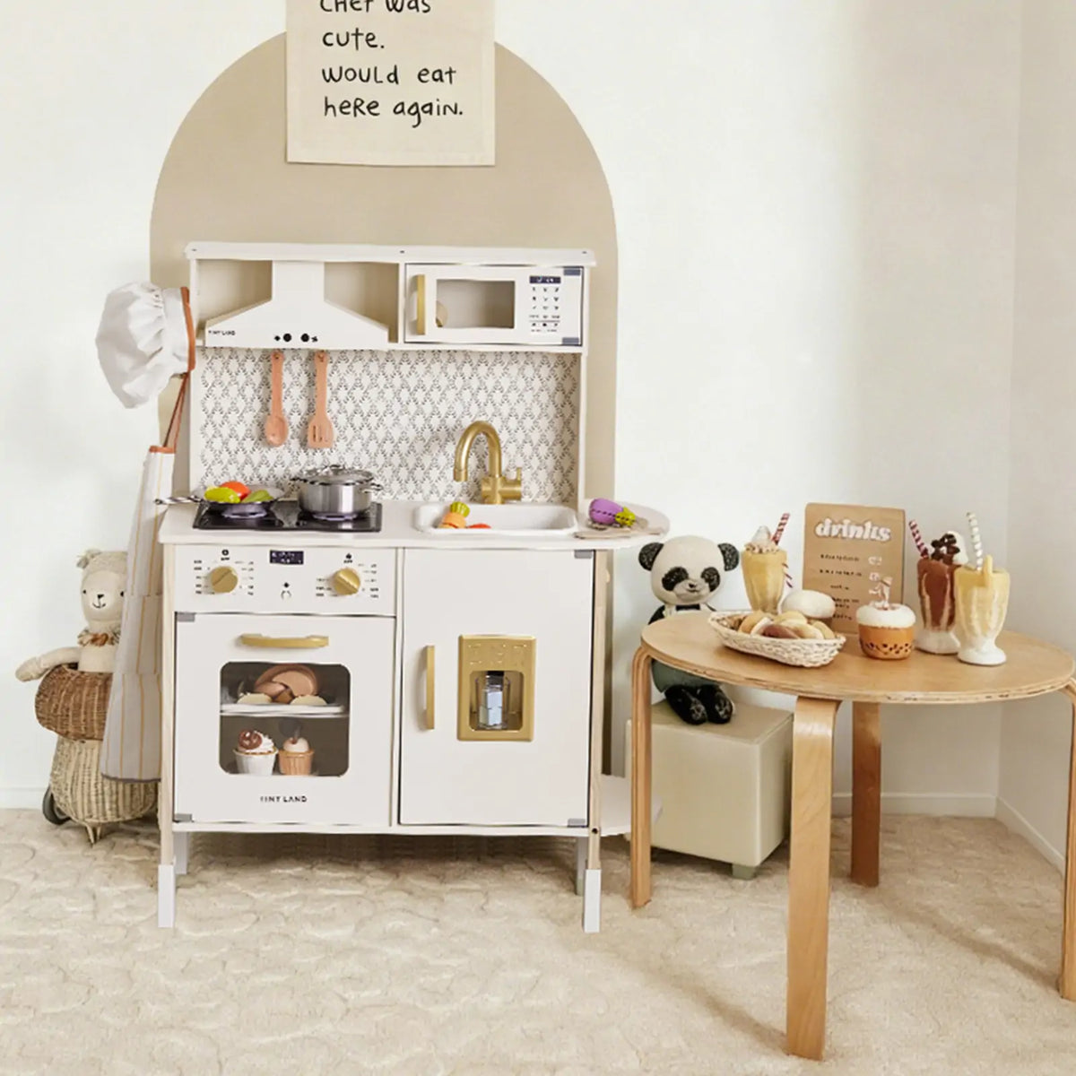Tiny Land PopJoy play kitchen in white and gold with stove, oven and sink; wooden utensils on Tampa Home & Garden Store