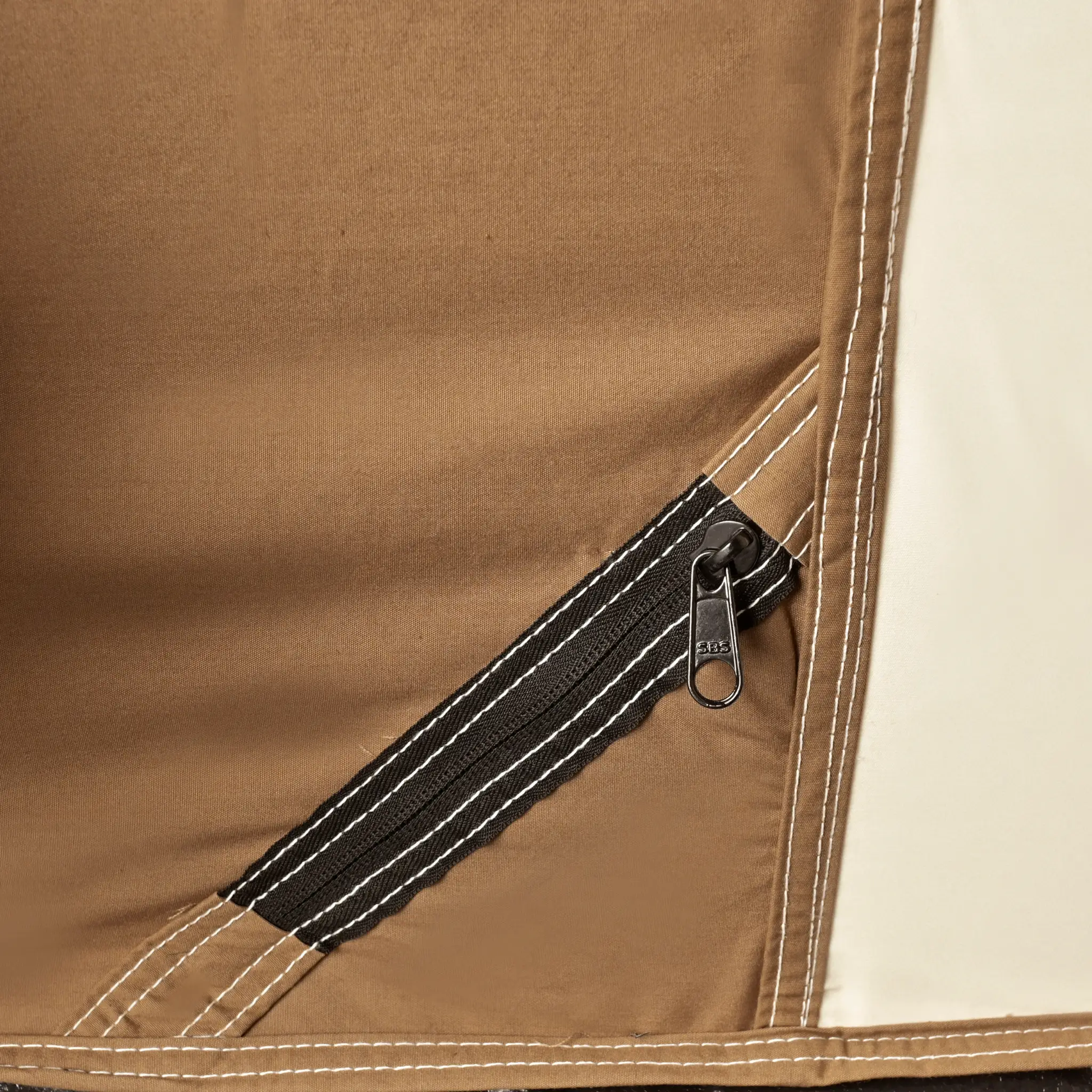 Brown canvas Prota Tent fabric close-up with white stitching and zipper on Tampa Home & Garden Store