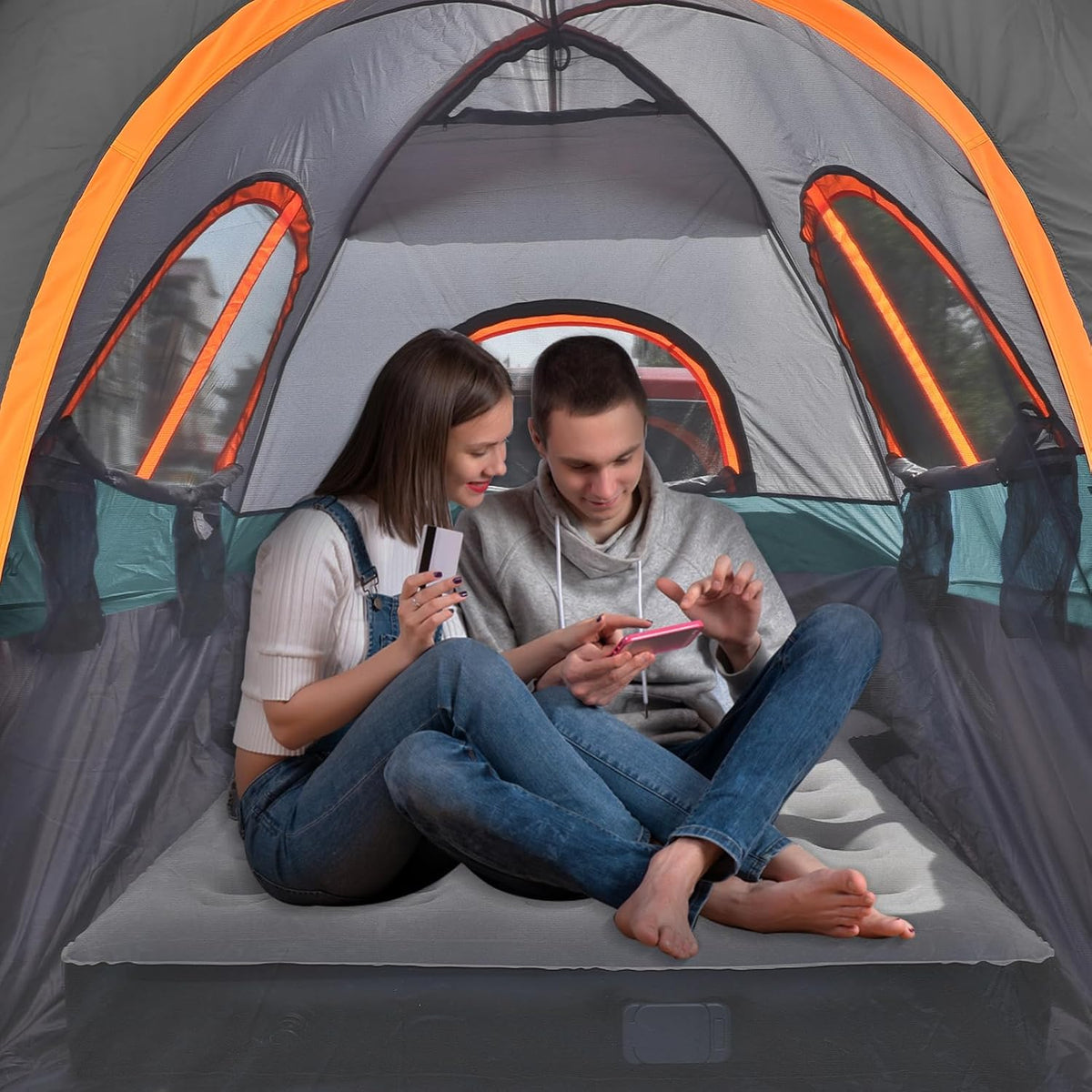 Umbrauto truck tent with awning for 5.5–5.8 ft beds, gray with orange trim, two people inside on Tampa Home & Garden Store
