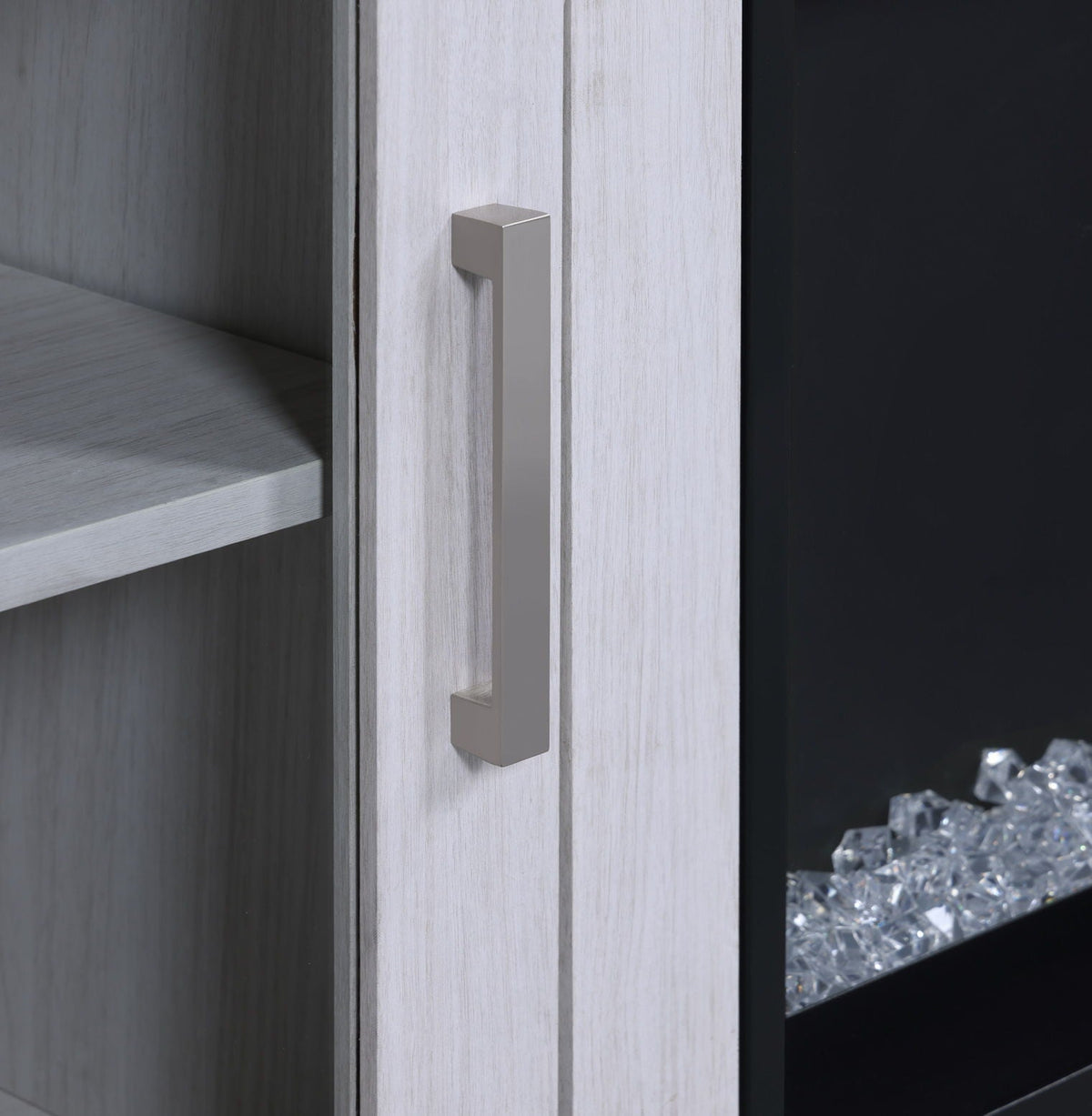 Whitewashed wood fireplace TV stand with a tall silver handle and glass panel with crystals on Tampa Home & Garden Store