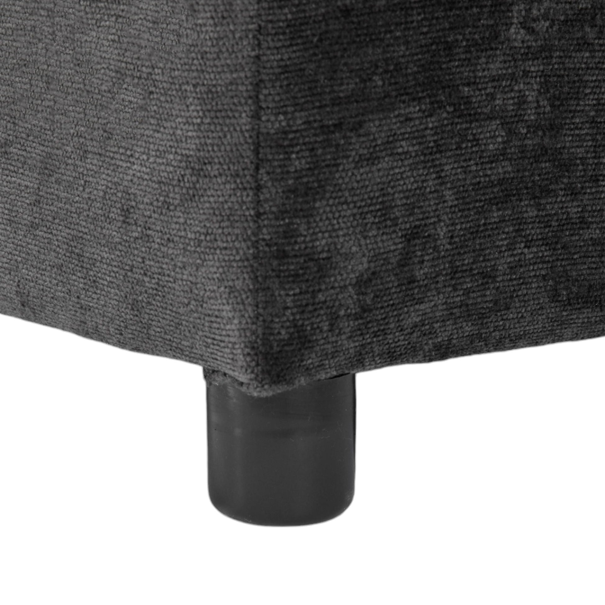 Sectional sofa leg close-up in charcoal gray fabric with a black metal leg base on Tampa Home & Garden Store