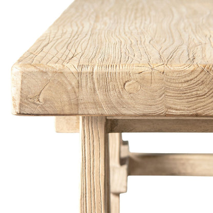 Trestle coffee table in solid reclaimed elm with light brown finish, close-up corner view on Tampa Home & Garden Store