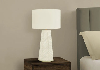 Ceramic table lamp with chevron-textured white base and white shade on nightstand on Tampa Home & Garden Store