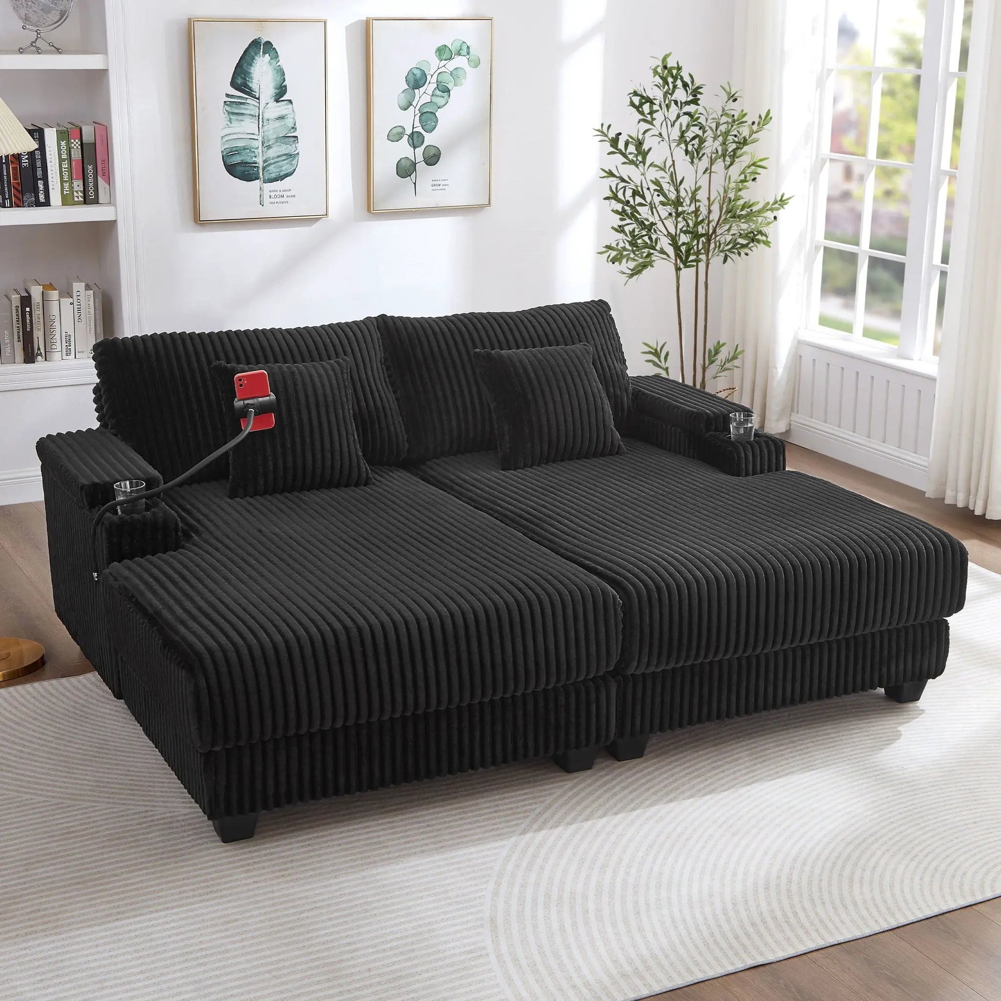 Modern chaise sofa in black corduroy with ribbed texture and low legs in living room on Tampa Home & Garden Store