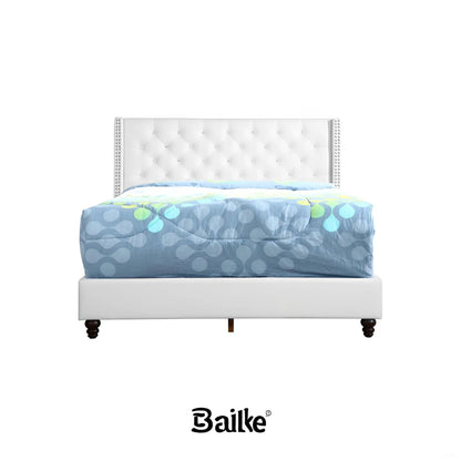 Upholstered nailhead trim chic bed in white with tufted headboard and dark wood legs on Tampa Home & Garden Store