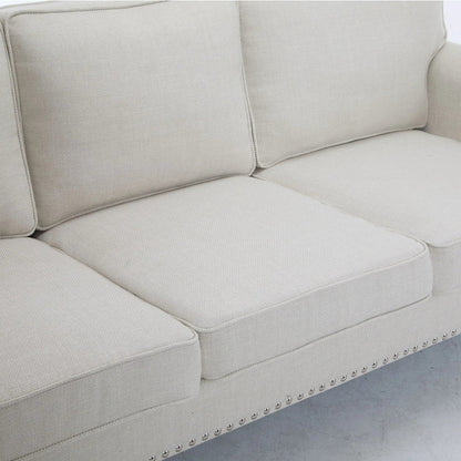 Rolled-arm beige stationary sofa with nailhead trim along the base, woven fabric texture on Tampa Home & Garden Store