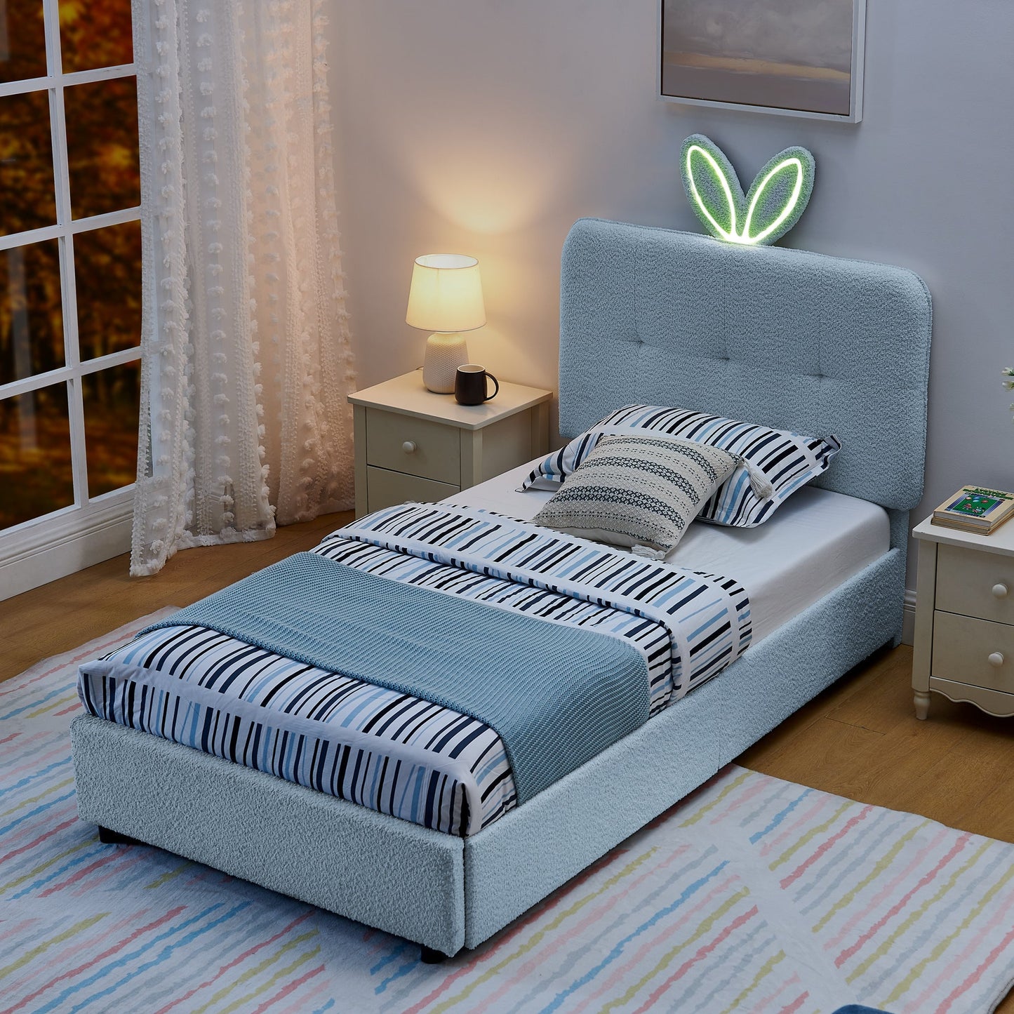 Two twin size kids upholstered beds with oversized rabbit ear headboards in light blue fabric on Tampa Home & Garden Store