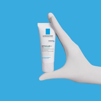 La Roche-Posay Effaclar H IsoBiome face cream white tube held by hand on blue background on Tampa Home & Garden Store