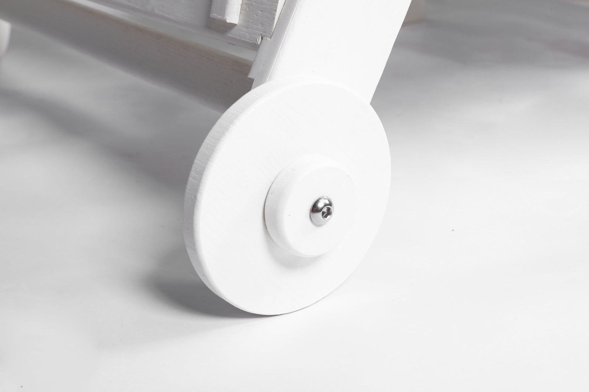 Outdoor lounge chair wheel close-up in white wood texture HDPE construction with metal axle on Tampa Home & Garden Store