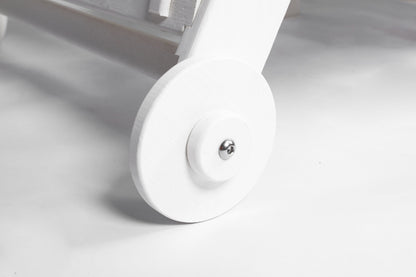 Outdoor lounge chair wheel close-up in white wood texture HDPE construction with metal axle on Tampa Home & Garden Store