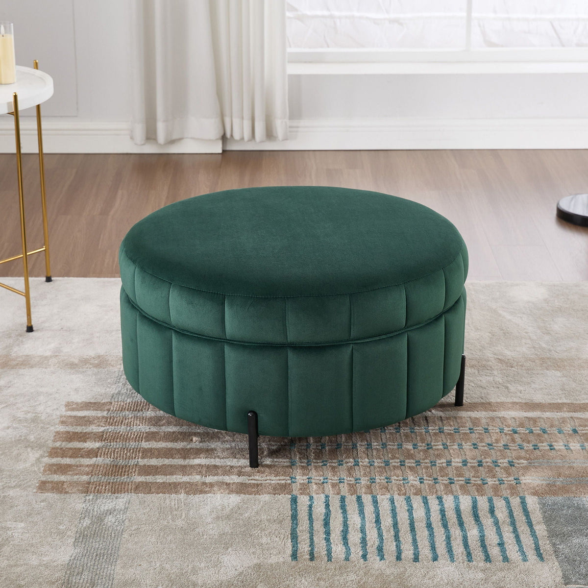 Upholstered green velvet round storage ottoman with channel tufting and black metal legs on Tampa Home & Garden Store