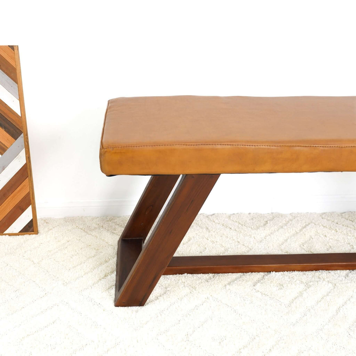 Light brown upholstered bench by HouseOfZazla with hand-stitched leather top and angled wooden legs on Tampa Home & Garden Store