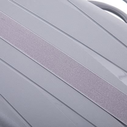 Luggage strap light gray fabric across ribbed hard-shell surface on Tampa Home & Garden Store