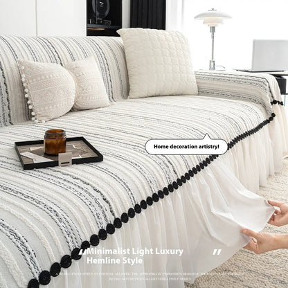 Sofa cover by FLIPSTYLEZLLC in white with black stripes, skirted hem and pom-pom trim on Tampa Home & Garden Store