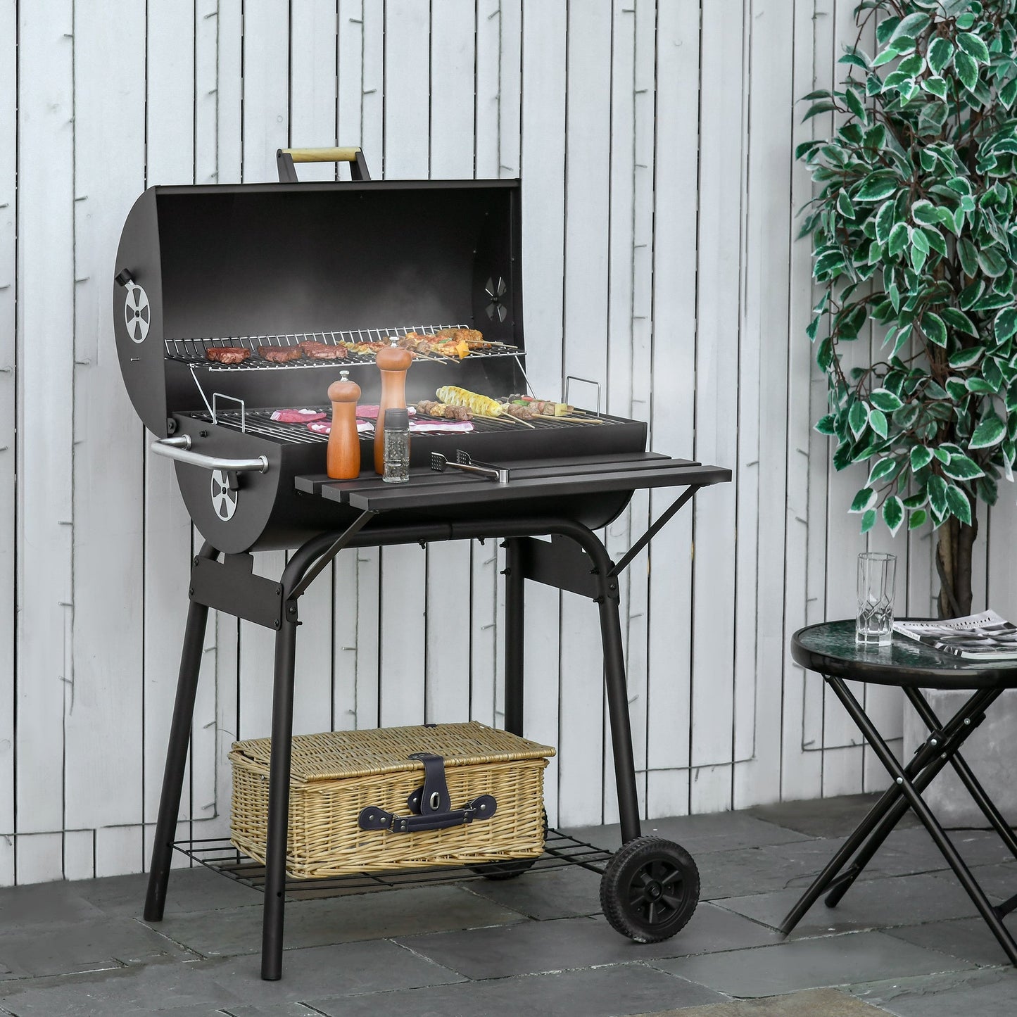 Outsunny portable barrel charcoal grill in black steel with wheeled stand on Tampa Home & Garden Store