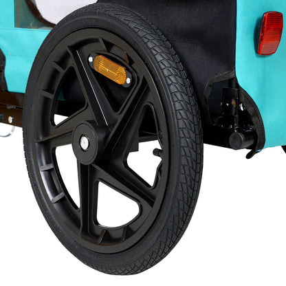 Pet trailer wheel close-up with black alloy rim, orange reflector, teal trailer fabric by HouseOfZazla on Tampa Home & Garden Store