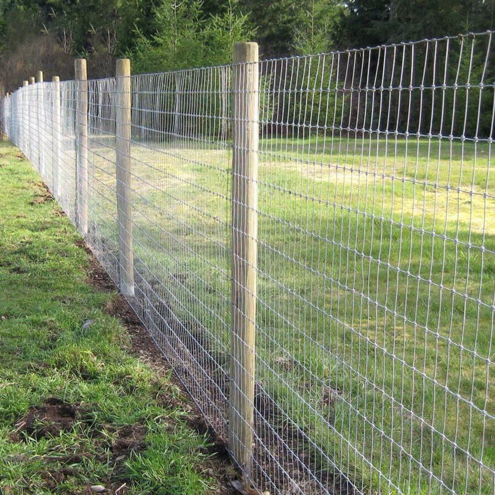 Farm Fence 4ft x 328ft, 14-gauge galvanized wire with wooden posts along a grassy field on Tampa Home & Garden Store