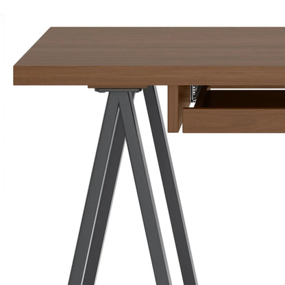 Sawhorse writing desk in solid wood with gray metal trestle legs and open lower drawer on Tampa Home & Garden Store