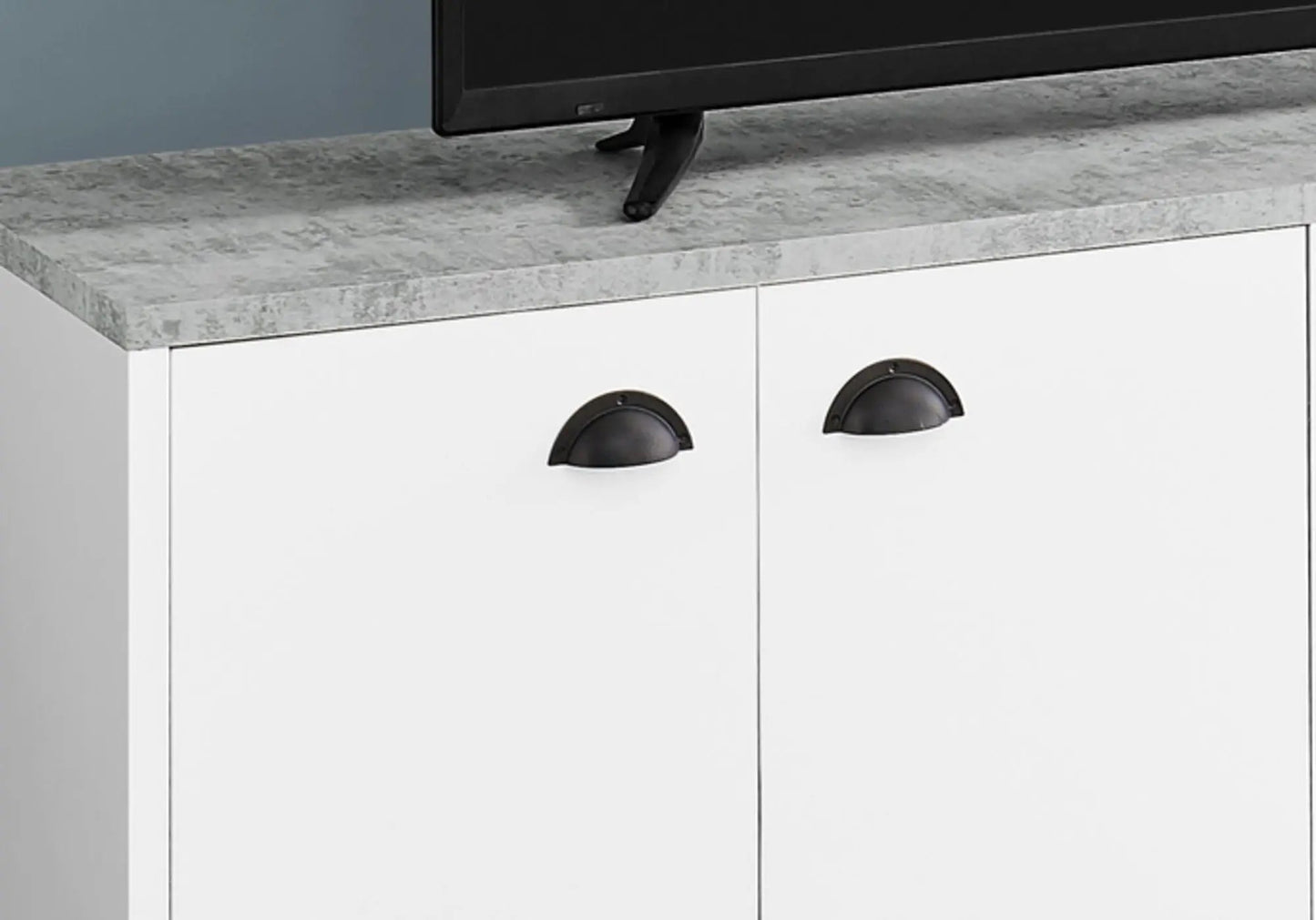 TV stand with gray stone-look top and white cabinet doors with black cup pulls on Tampa Home & Garden Store