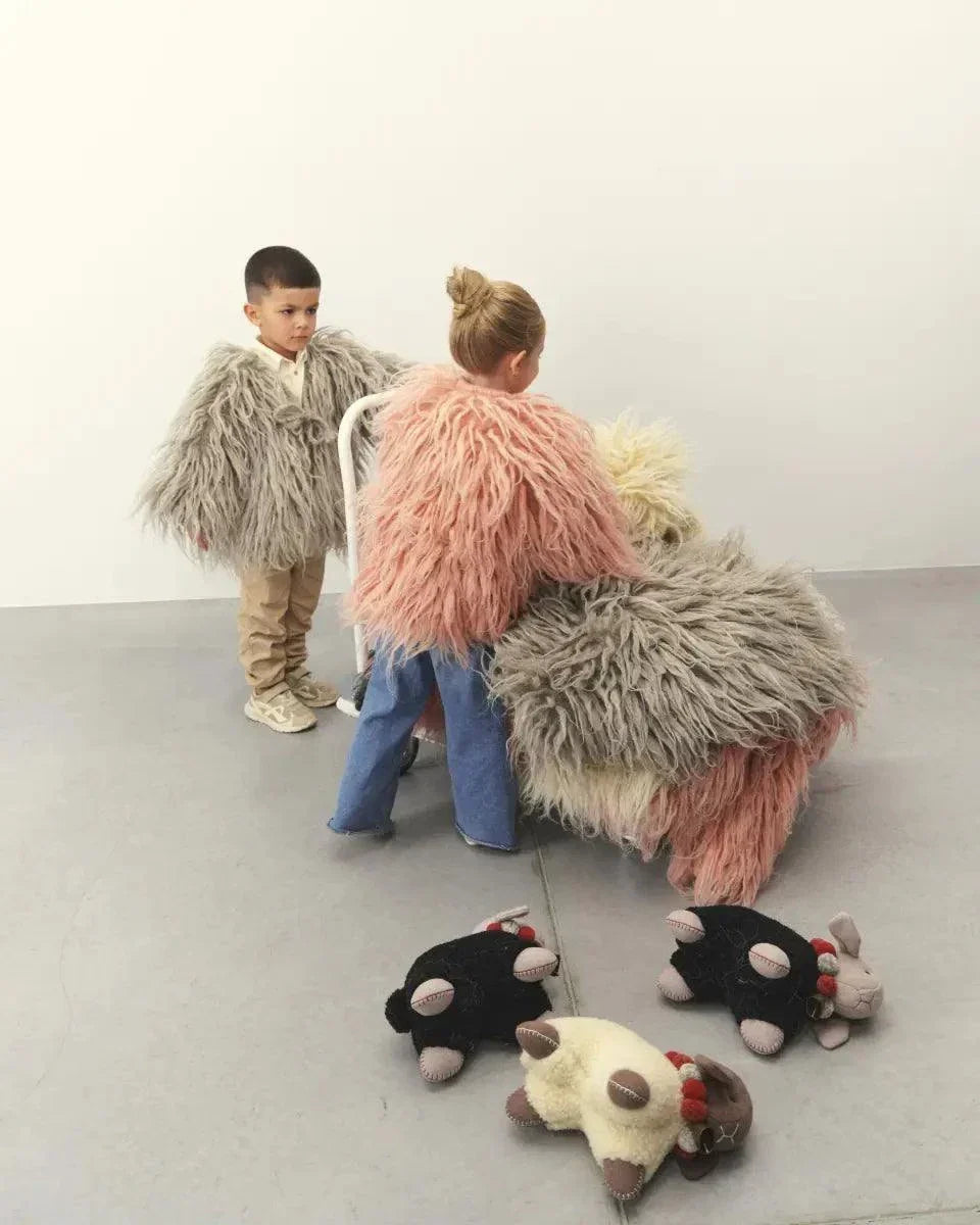 Large wool lamb toy with pink shaggy fur; pastel gray and cream lambs nearby on Tampa Home & Garden Store