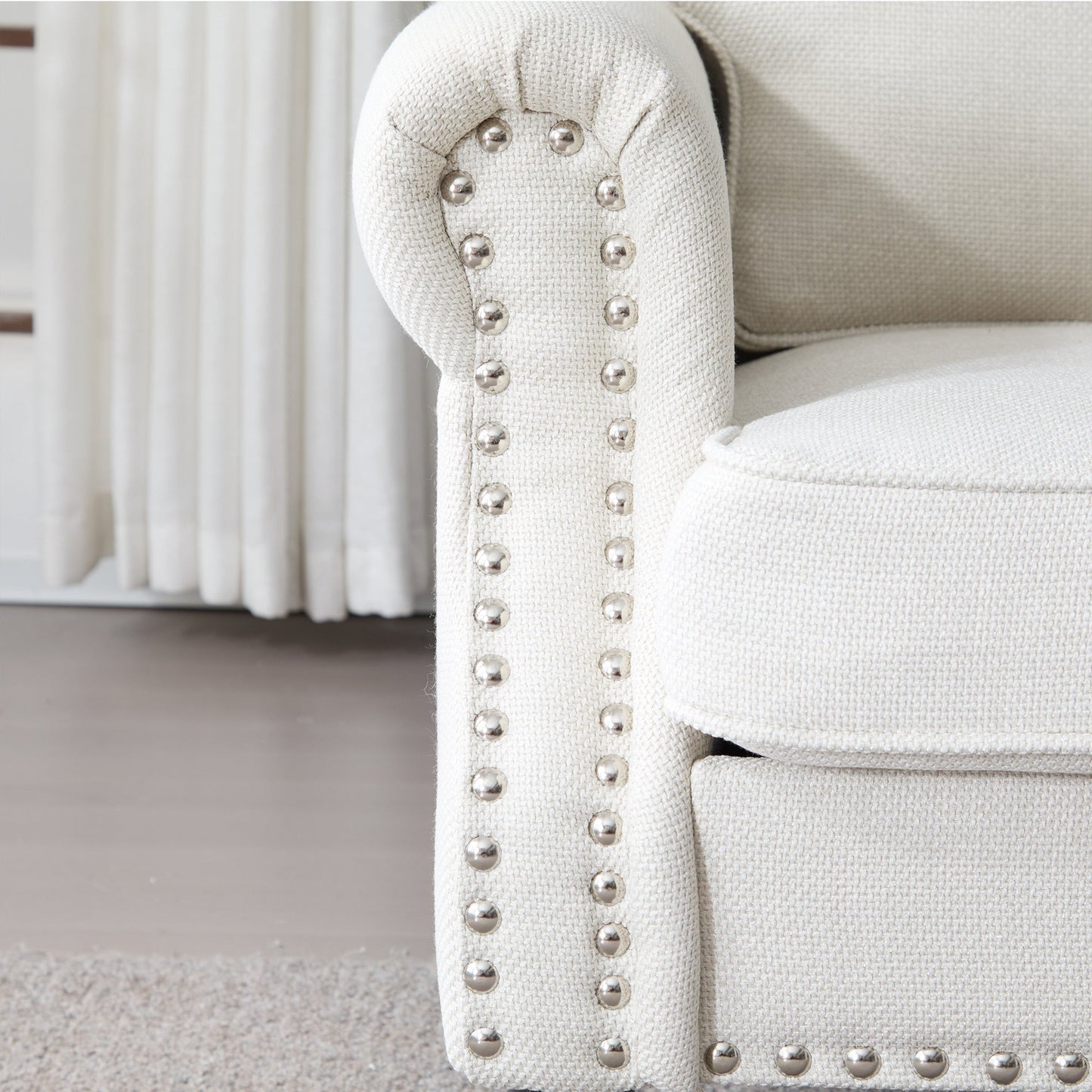 68 Inch faux leather rolled-arm sofa with nailhead trim cream fabric along studded arm on Tampa Home & Garden Store