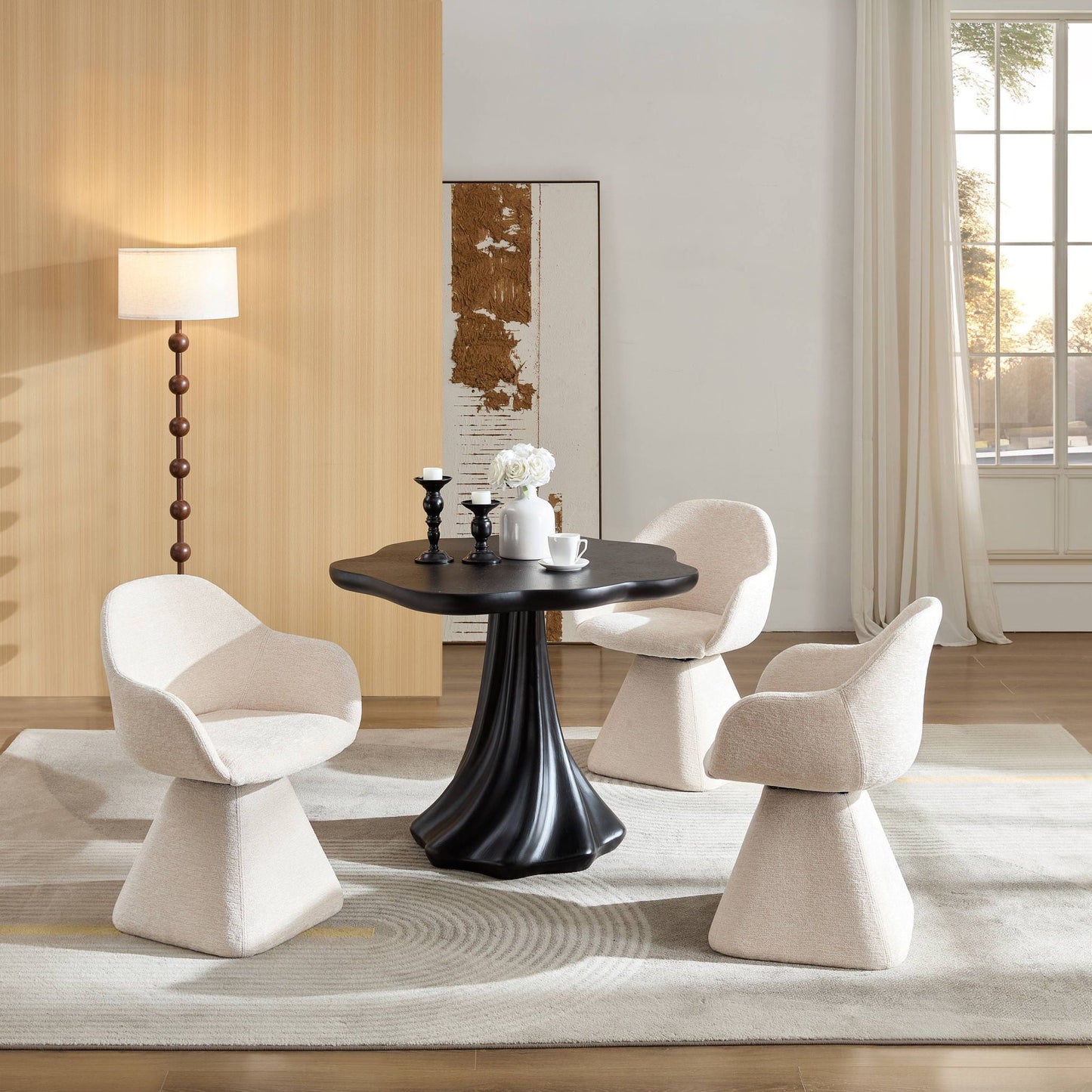 Black sculptural round dining table with petal-shaped top and root-texture base, six beige chairs on Tampa Home & Garden Store