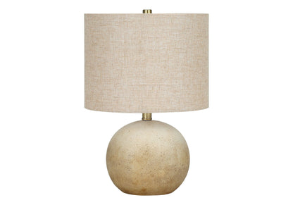 Table lamp with beige linen shade and stacked speckled stone spherical base on Tampa Home & Garden Store
