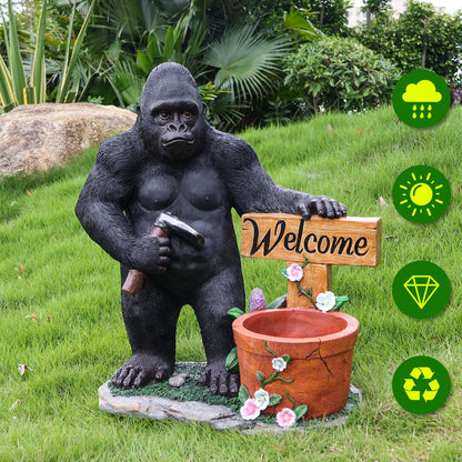 Outdoor chimpanzee garden statue with hammer beside welcome sign flower-pot planter on Tampa Home & Garden Store