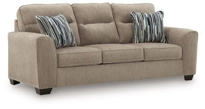 Olten beige fabric sofa with three seat cushions and striped pillows on Tampa Home & Garden Store