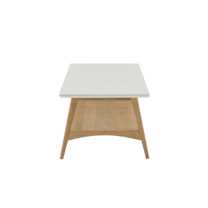 Modern coffee table with white tabletop and natural oak angled legs, open storage shelf on Tampa Home & Garden Store