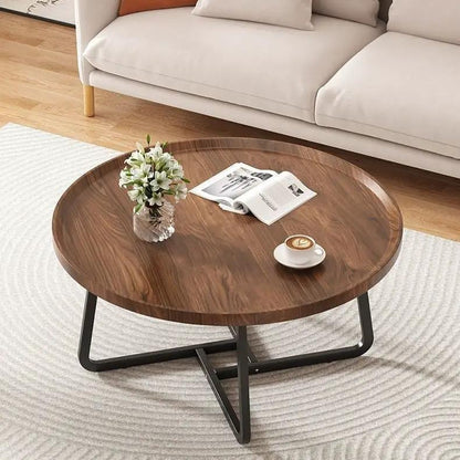 Round solid wood tea table with black metal legs in a living room with vase and cup on Tampa Home & Garden Store