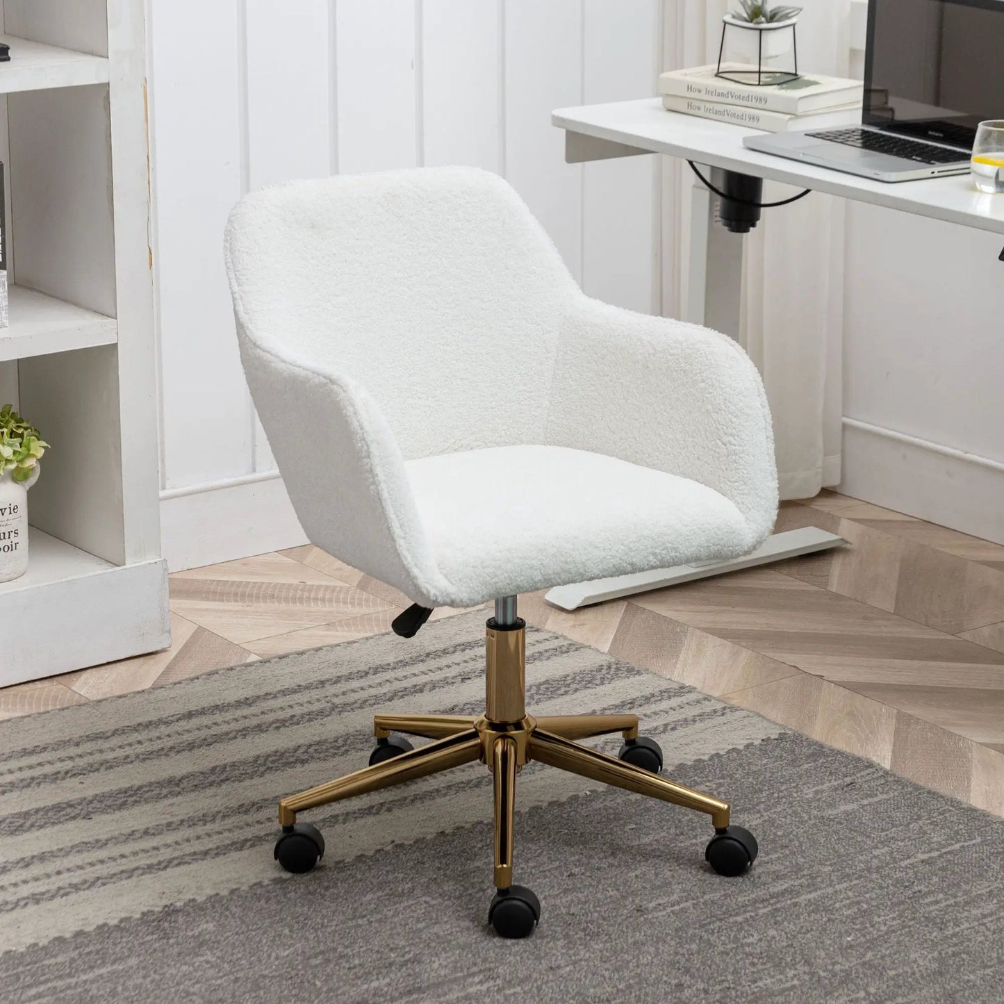 Modern adjustable height 360° revolving chair in white boucle with gold base and wheels on Tampa Home & Garden Store